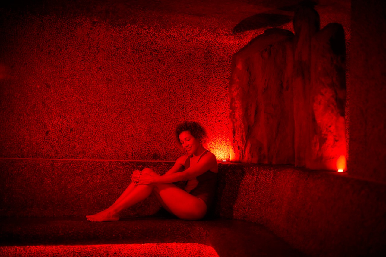 Woman relaxing in a glowing Volcanic Steam room.